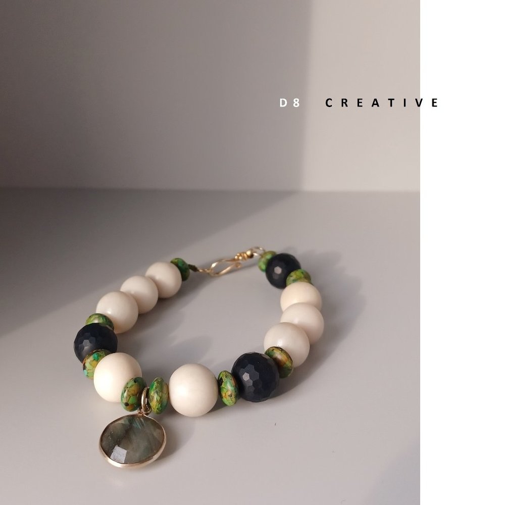 White rive stone with black onyx and sterling silver pendant bracelet